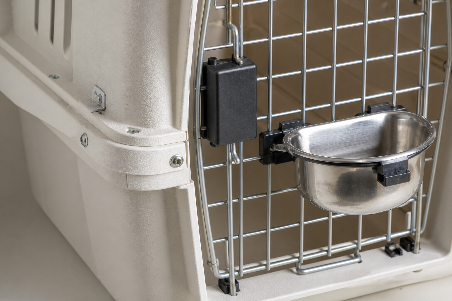 Close-up of IATA-compliant pet crate hardware with ventilation grille and secure metal door